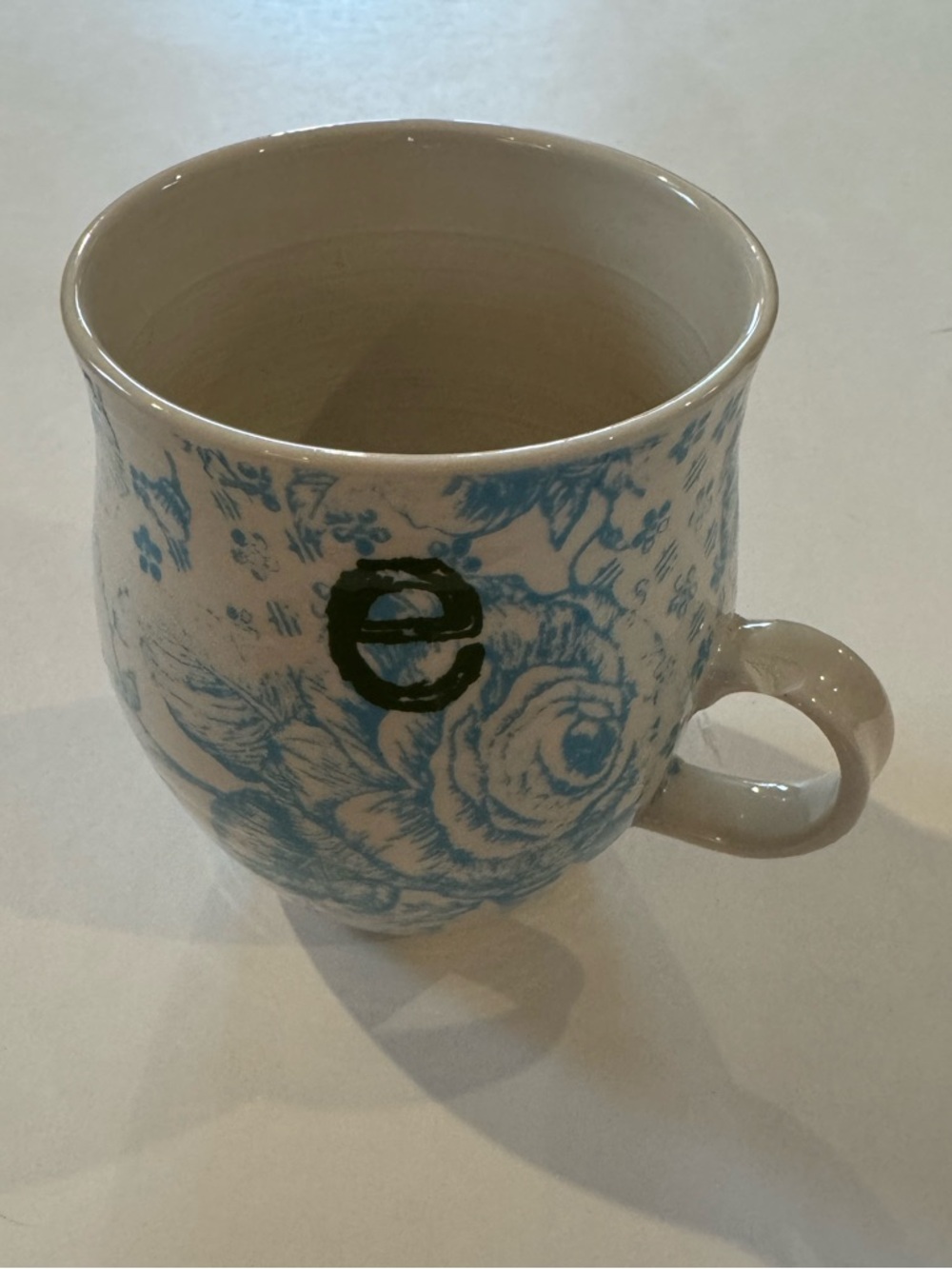 Anthropologie Light Blue and White Floral Ceramic Mug with ‘E’ Initial